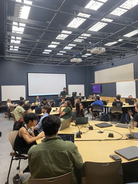 Students working at tables during the 2025 MTU Vehicle Hackathon